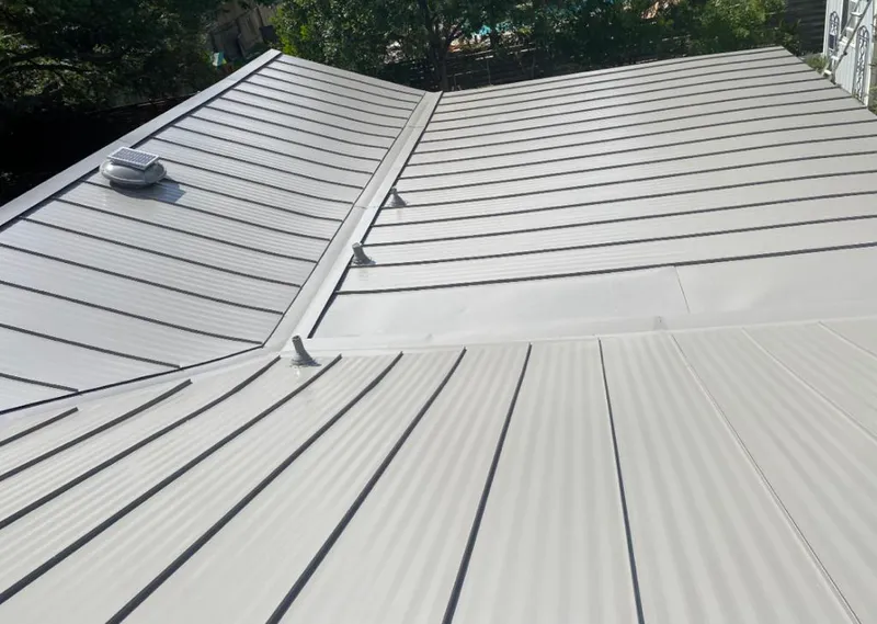 Solar attic fan installed on a metal roof for Roof Ventilation in Diboll
